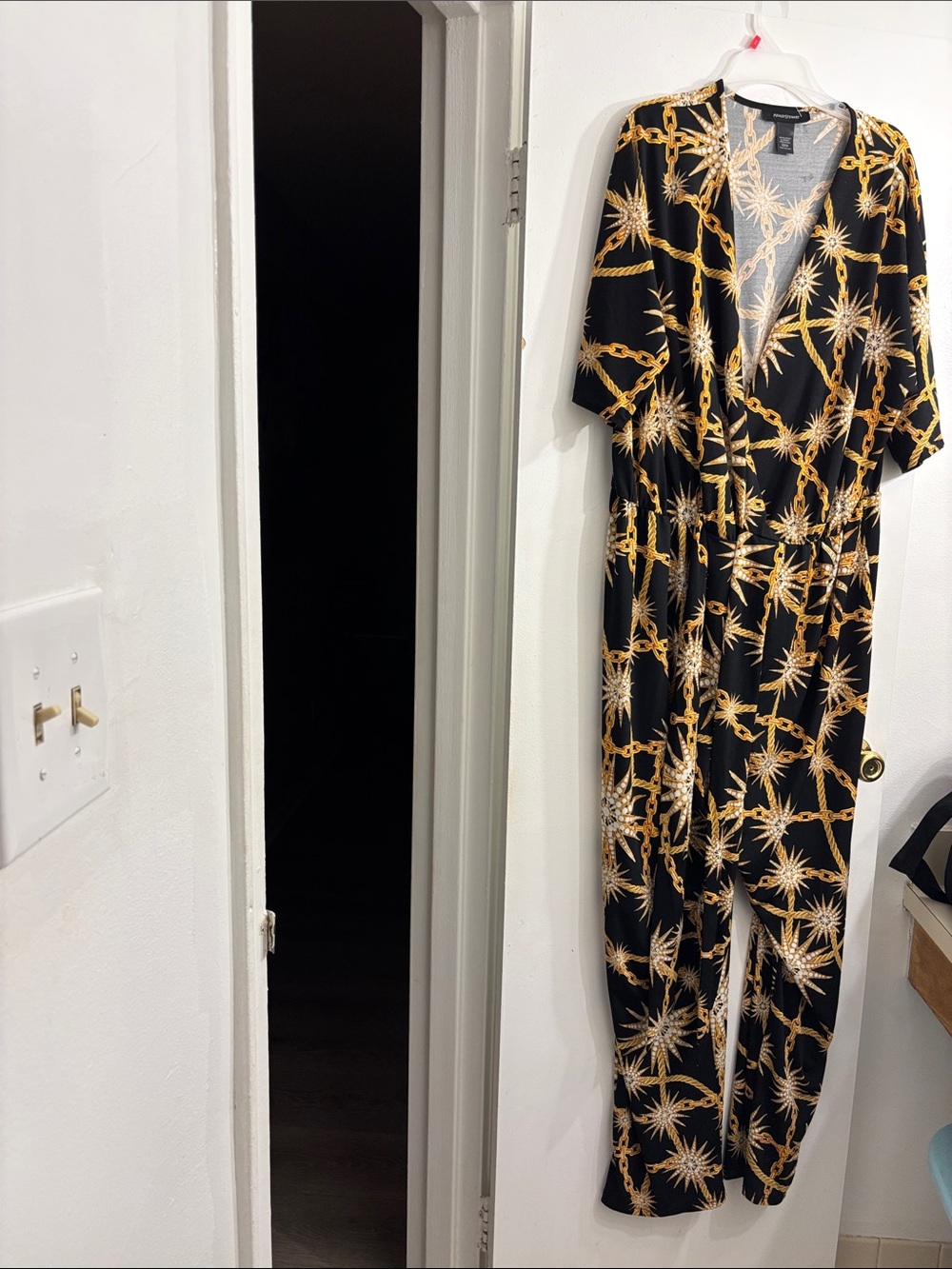 Ashley Stewart Black Jumpsuit with Gold Chain & Starburst Motif